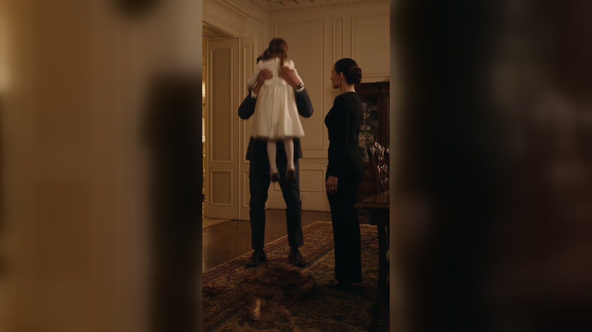 A father holds and reassures a child after a difficult birthday moment
