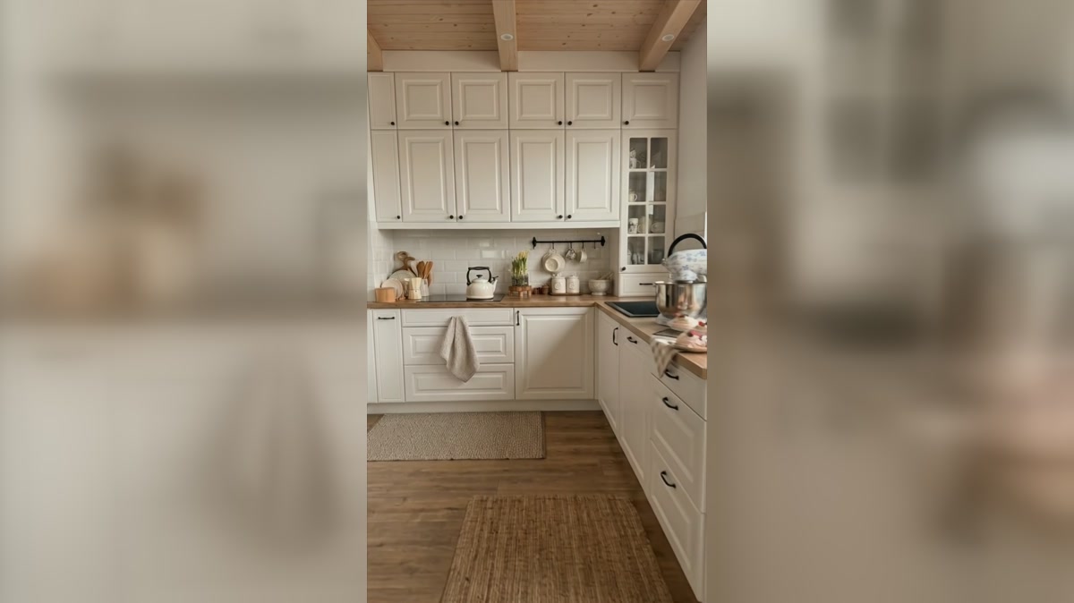 White framed cabinets, hanging mugs, and practical baking storage