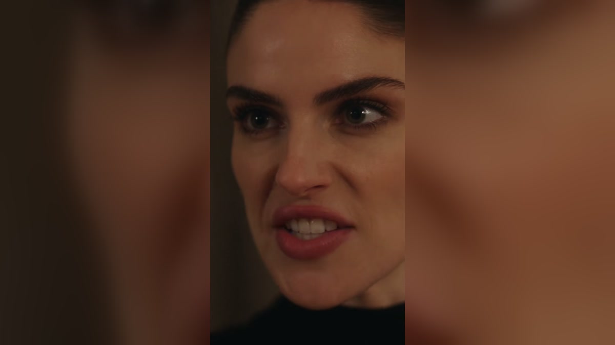 A witness approaches during a tense formal gathering