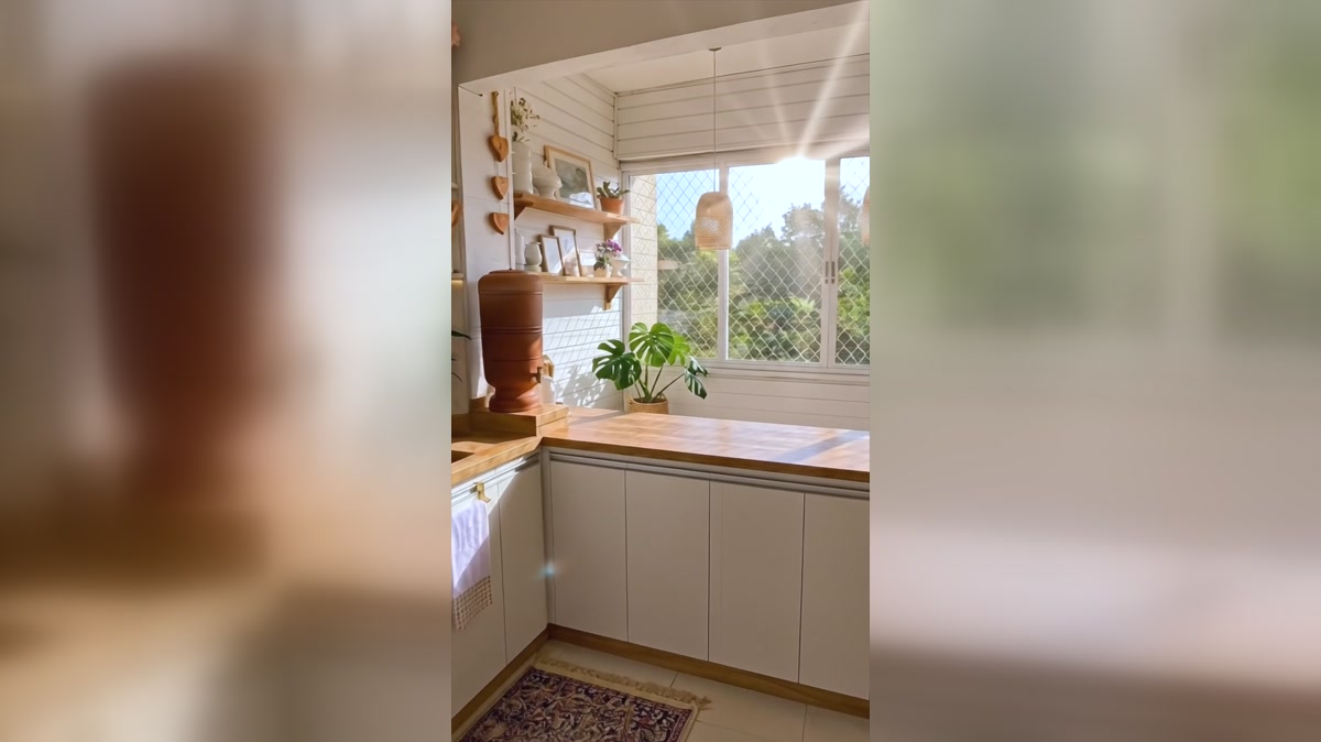 Warm island and patterned runner in the bright neutral kitchen