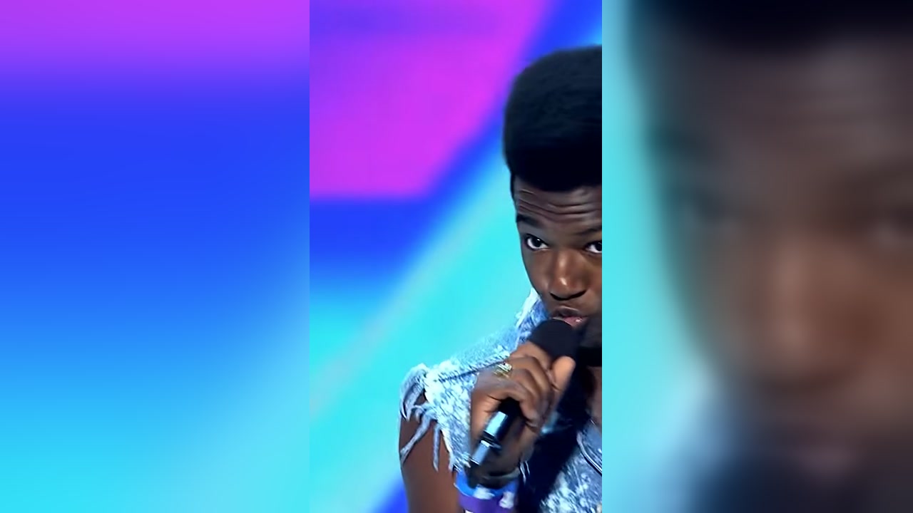 Willie Jones singing into a microphone during his X Factor audition